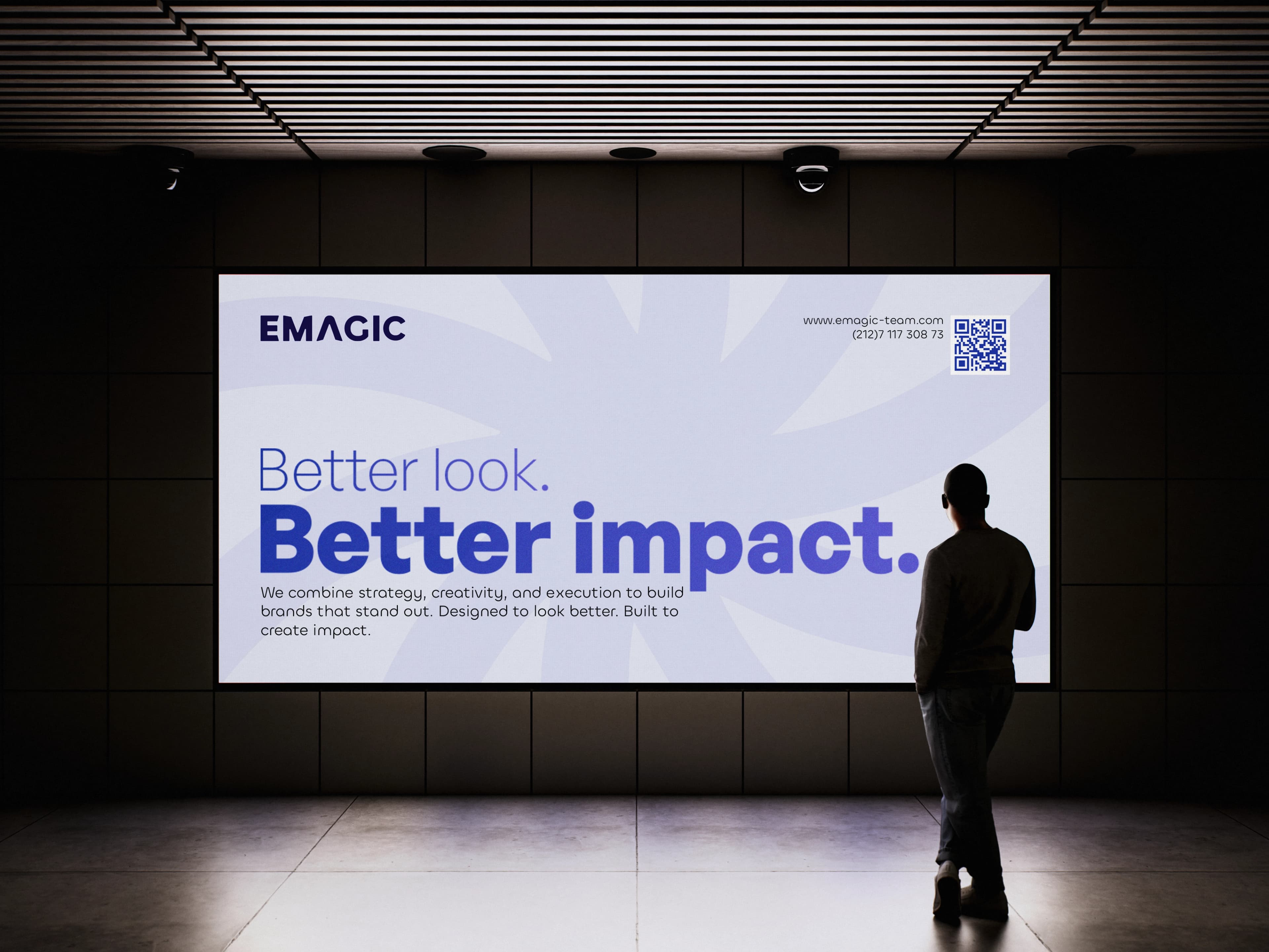 Emagic's Better Impact billboard displayed on a large indoor screen